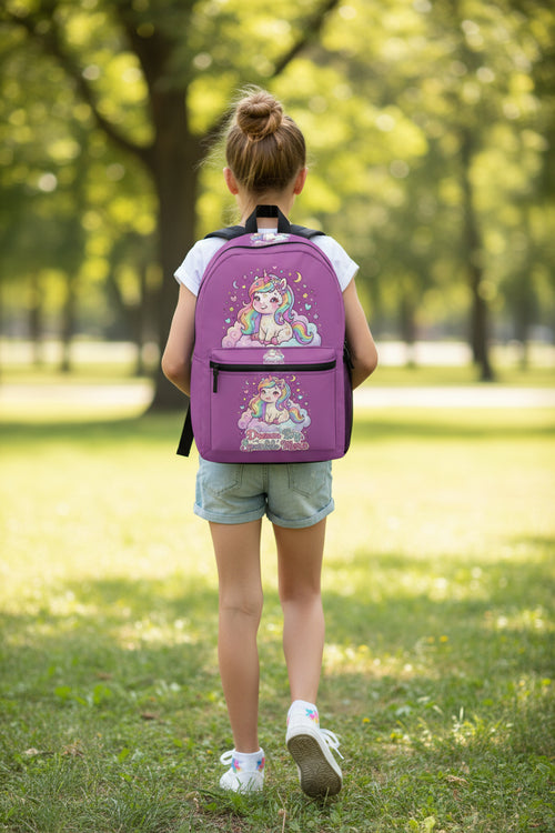 A purple backpack featuring a cute cartoon unicorn illustration on the front pocket and main compartment, with the text 'Dream Big Sparkle Mice' below the front graphic. The backpack has black zippers, a black top handle, and a white background.