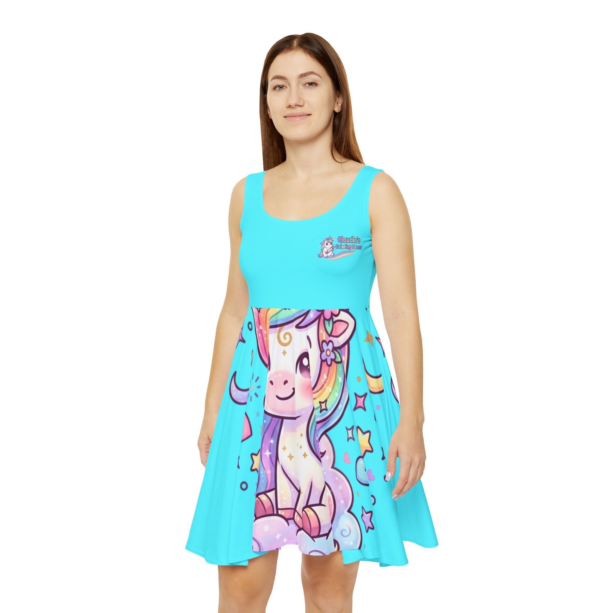 A woman modeling a bright turquoise sleeveless skater dress with a colorful cartoon unicorn graphic on the front. The dress features a small graphic on the left chest with the text 'The Magic of Nature'.