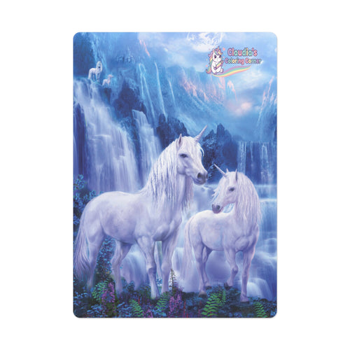 A rectangular printed card or coaster featuring a fantasy scene of two white unicorns standing in front of blue waterfalls and icy mountains. The unicorn artwork is centered on a white background, and a small 'Cloudie's Coloring Book' logo appears near the top right of the printed design.