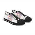 A pair of low-top canvas sneakers with a white upper, black toe caps, black laces, and black soles. The sides feature a colorful cartoon illustration of a cute unicorn girl with pastel rainbow hair and a horn.