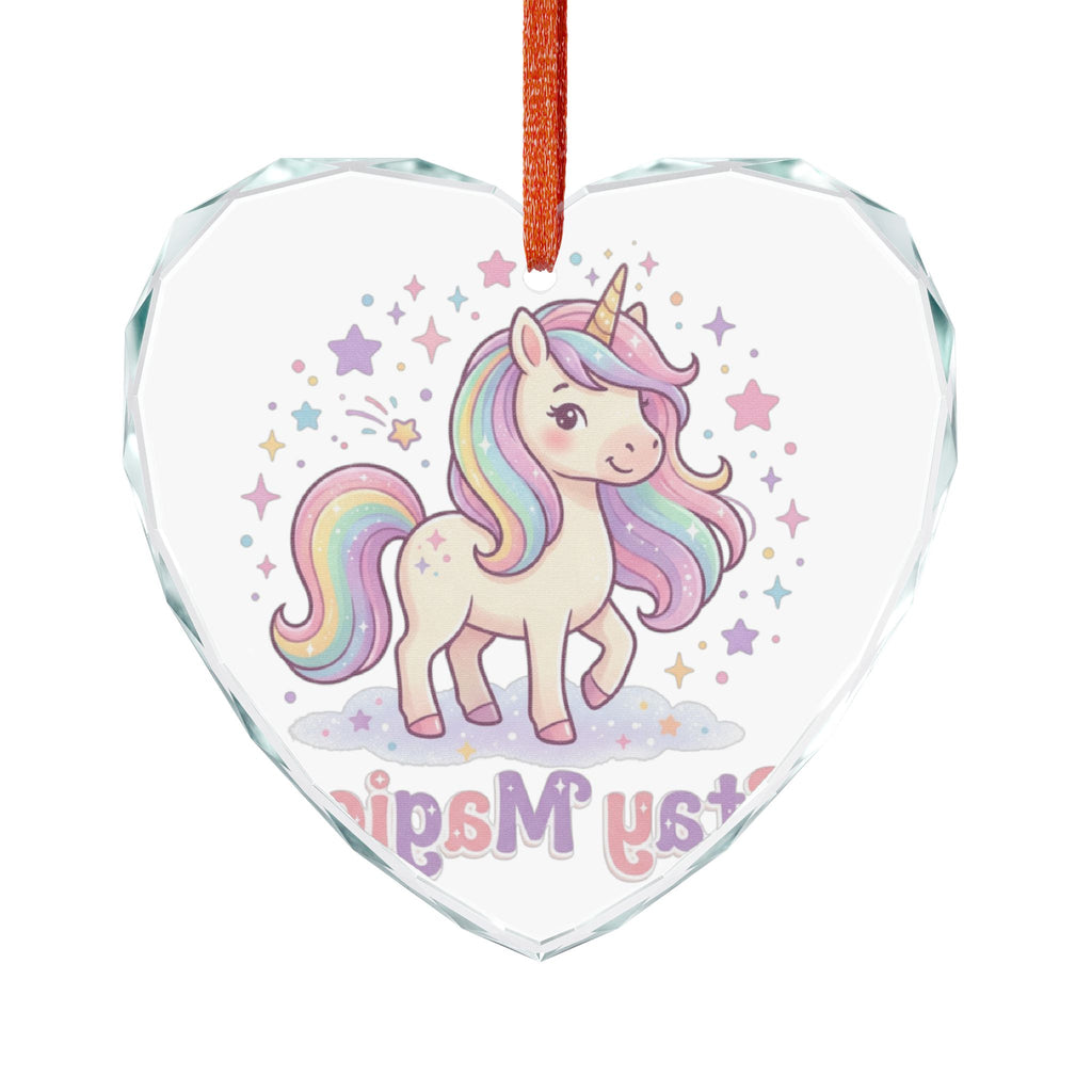 A heart-shaped clear glass ornament featuring a cute cartoon unicorn with a pastel rainbow mane and tail, surrounded by stars, with the words 'Unicorns Must' at the bottom. The ornament hangs from a red ribbon against a plain white background.