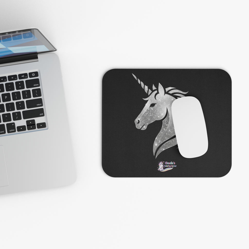 Black mouse pad with a logo and a laptop on a white surface