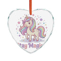 A heart-shaped clear glass ornament featuring a colorful cartoon unicorn with a pastel rainbow mane and tail, surrounded by stars and the words 'Stay Magic' in pink and purple lettering. An orange hanging ribbon is threaded at the top.