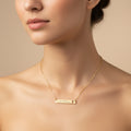 Gold necklace with 'Girl Mom' and a cross on a white background