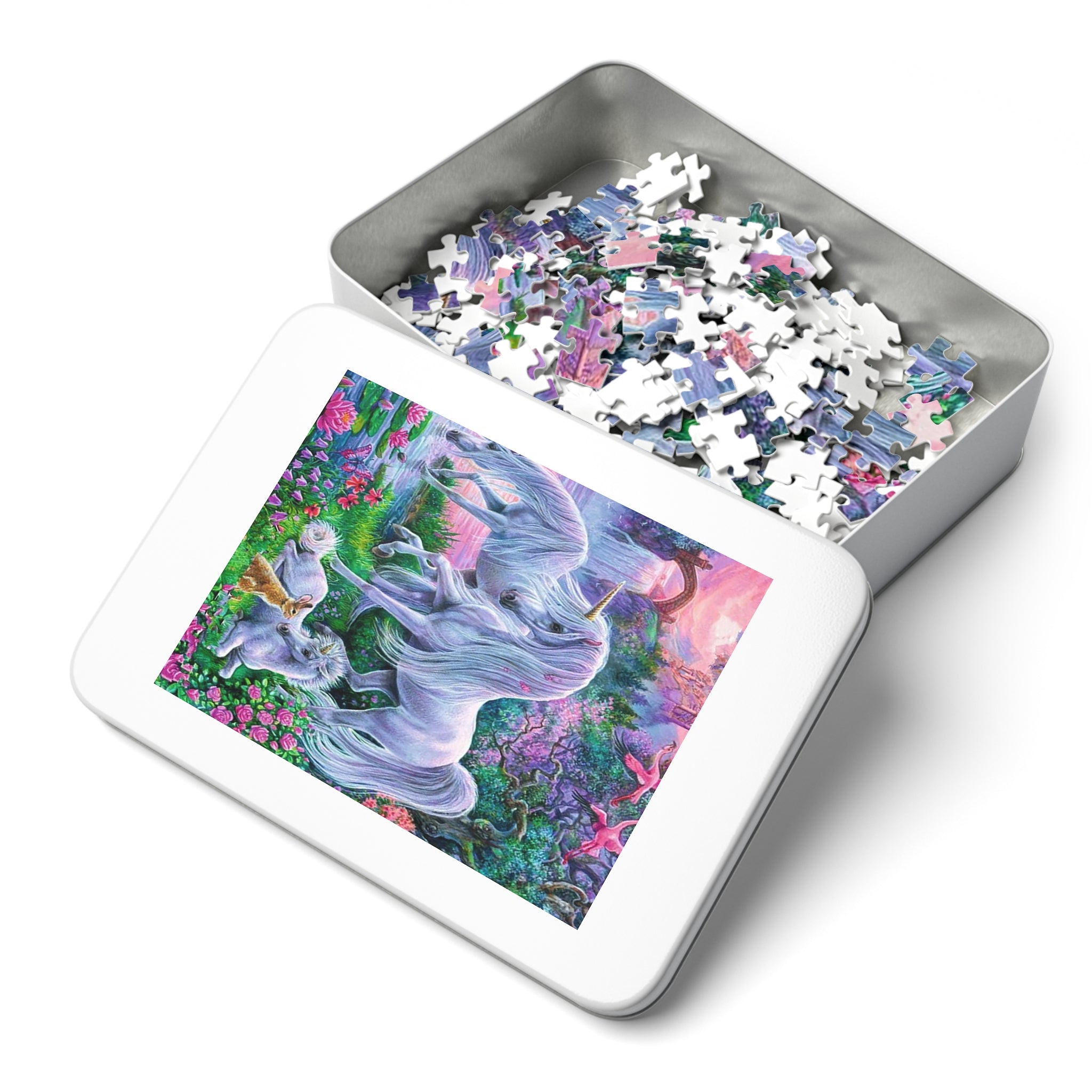 A jigsaw puzzle tin shown open on a white background, with the lid displaying a colorful fantasy unicorn illustration and the inside filled with partially assembled puzzle pieces.